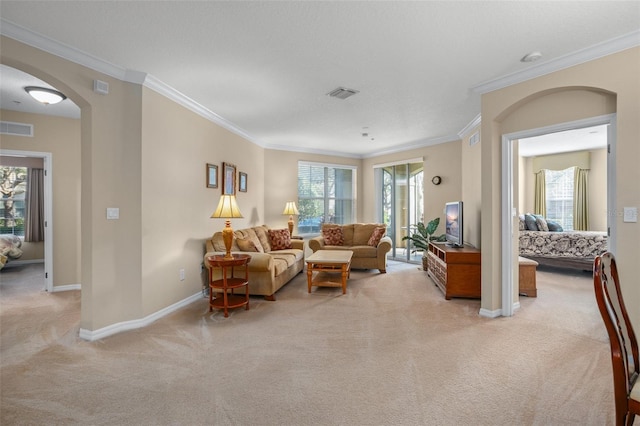 living area featuring arched walkways, carpet, visible vents, and baseboards