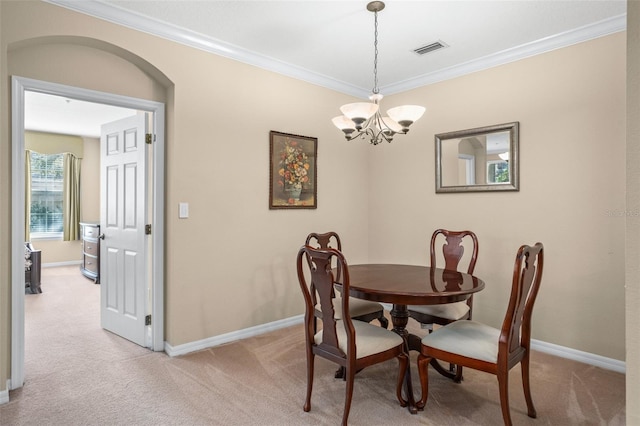 dining area with light carpet, visible vents, arched walkways, and crown molding