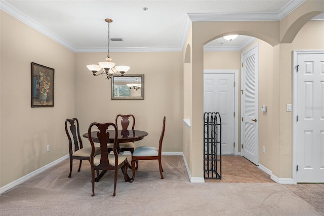 dining area with baseboards, carpet, and crown molding