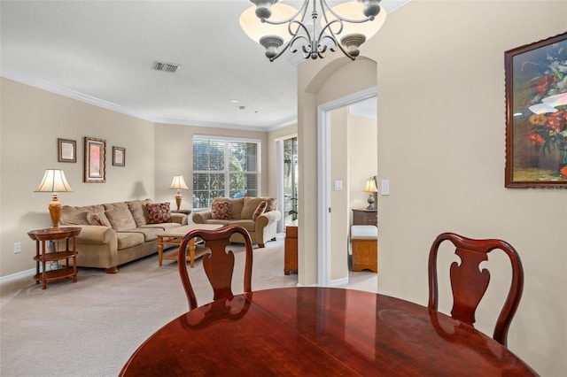 dining room with light colored carpet, visible vents, an inviting chandelier, ornamental molding, and baseboards