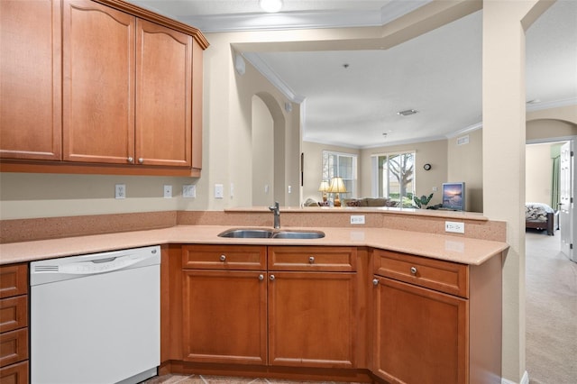 kitchen with arched walkways, crown molding, white dishwasher, a sink, and a peninsula