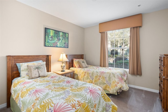 carpeted bedroom featuring baseboards