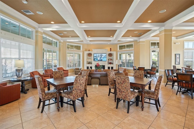 dining room with a healthy amount of sunlight, visible vents, coffered ceiling, and beamed ceiling