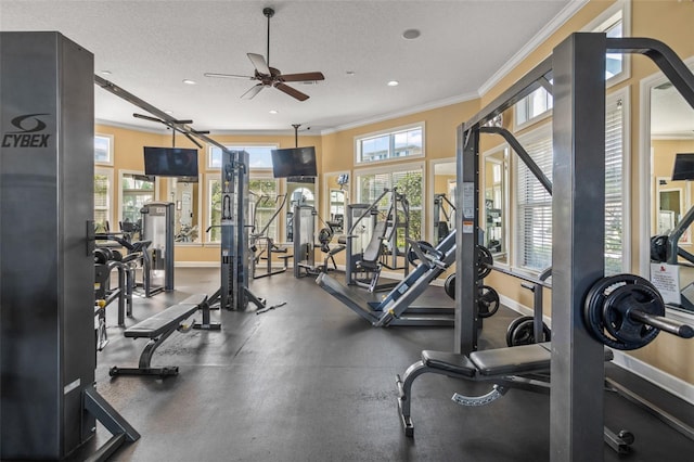 exercise room featuring a textured ceiling, ornamental molding, a ceiling fan, and baseboards