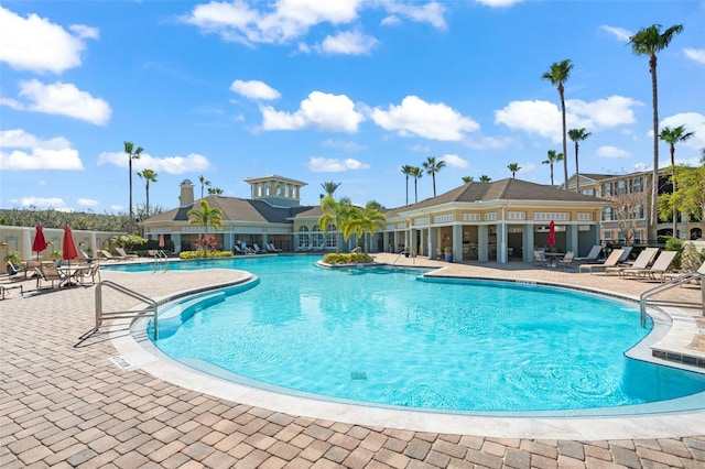 pool featuring a patio and fence