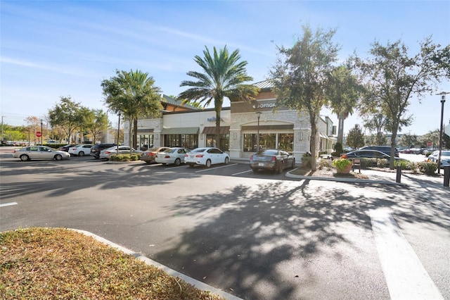 view of building exterior with uncovered parking