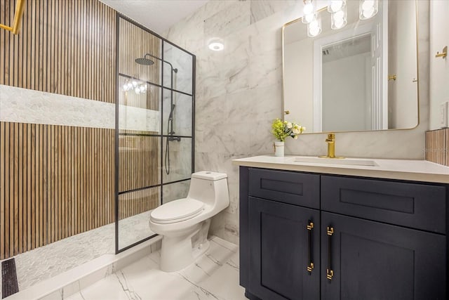 bathroom with toilet, vanity, tile walls, marble finish floor, and tiled shower