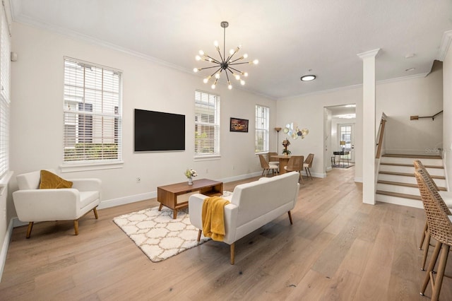 living area featuring light wood-style floors, stairs, ornamental molding, and a chandelier