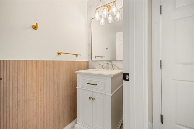 bathroom featuring a wainscoted wall and vanity