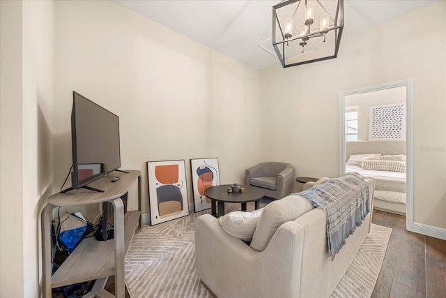 interior space with a chandelier, baseboards, and wood finished floors