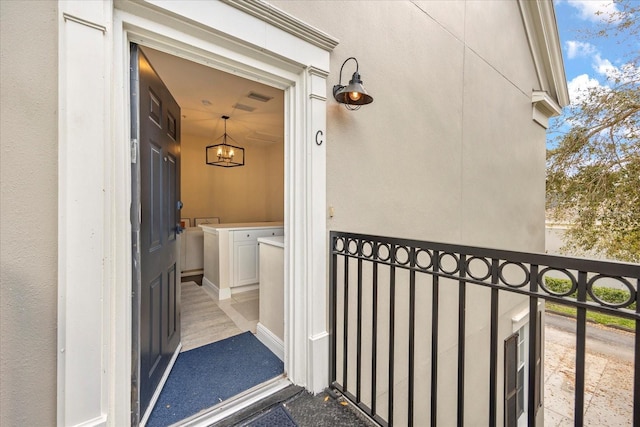 doorway to property featuring stucco siding