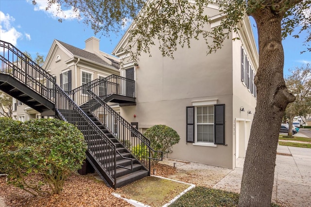 exterior space with stairs and stucco siding