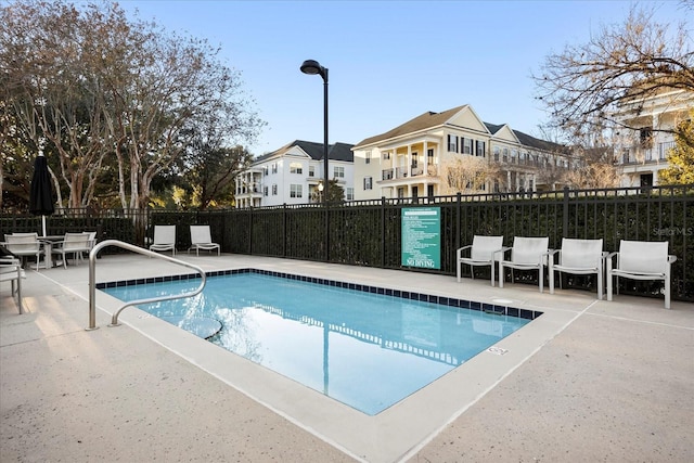 pool featuring a patio area and fence