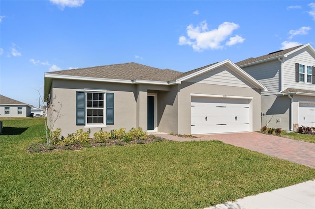 single story home featuring a garage, a shingled roof, decorative driveway, stucco siding, and a front lawn