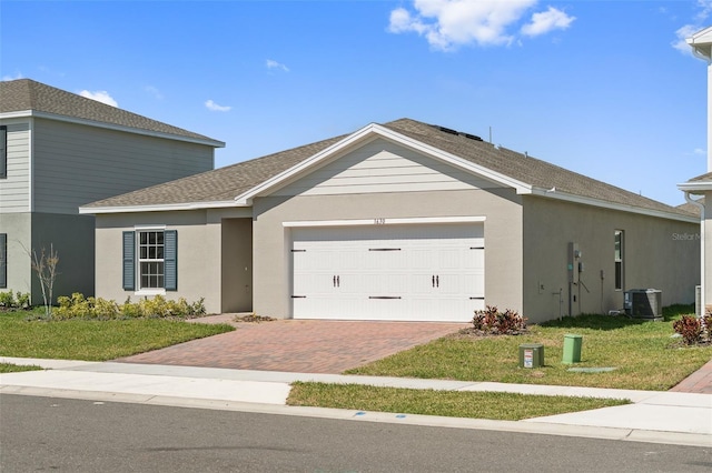 view of front of property featuring a garage, a front lawn, and stucco siding