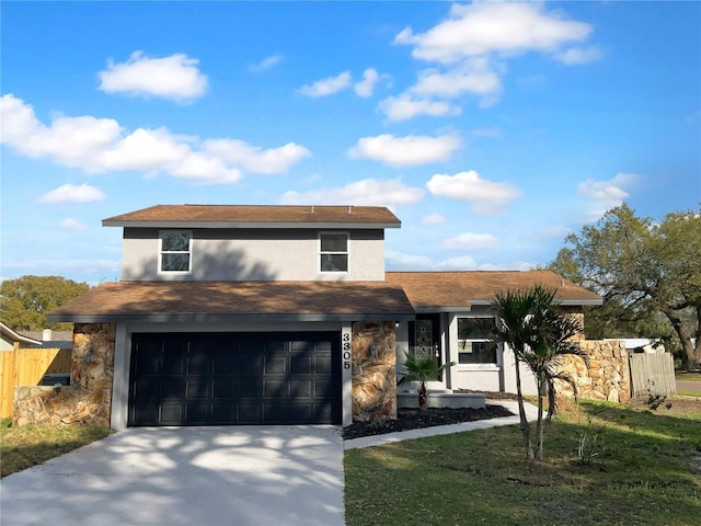 view of front of property with a garage, concrete driveway, fence, a front lawn, and stucco siding