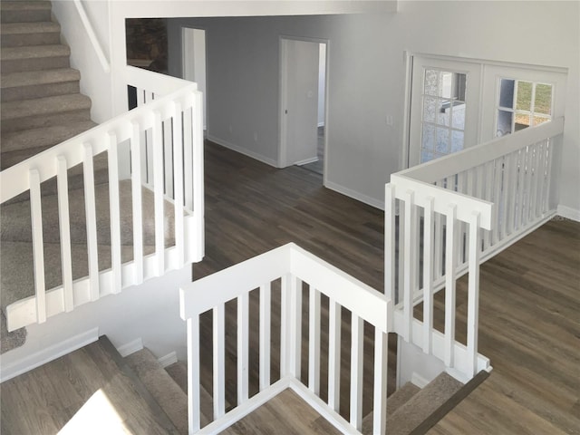 stairway with wood finished floors and baseboards