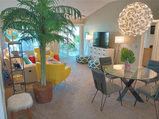 dining space featuring lofted ceiling and carpet flooring