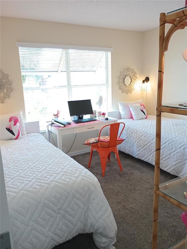 bedroom featuring a textured ceiling, multiple windows, and carpet