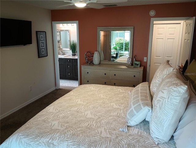 bedroom with connected bathroom, carpet floors, a sink, visible vents, and baseboards