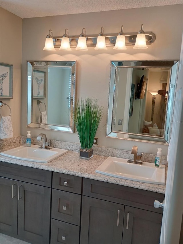 full bathroom with double vanity and a sink