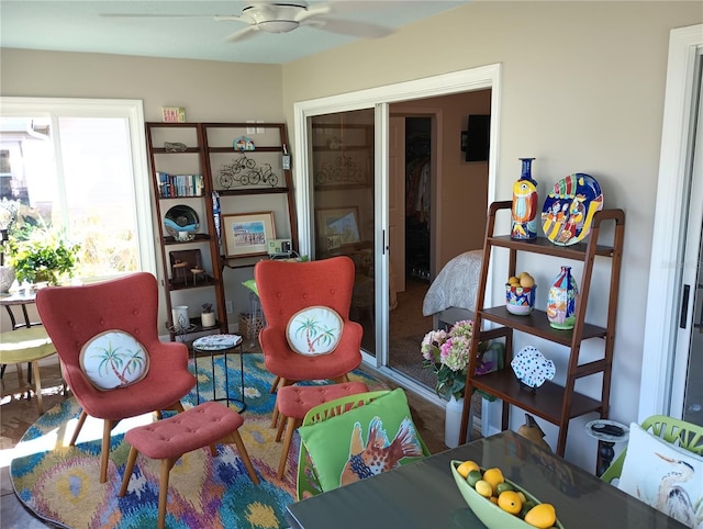 living area featuring a ceiling fan