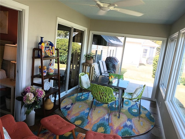 sunroom / solarium featuring ceiling fan