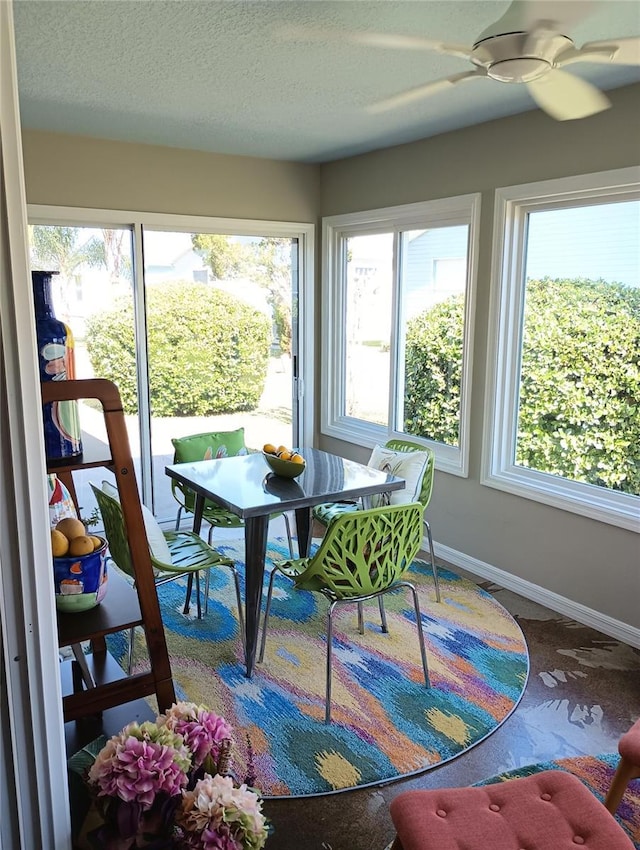 sunroom with a ceiling fan and plenty of natural light