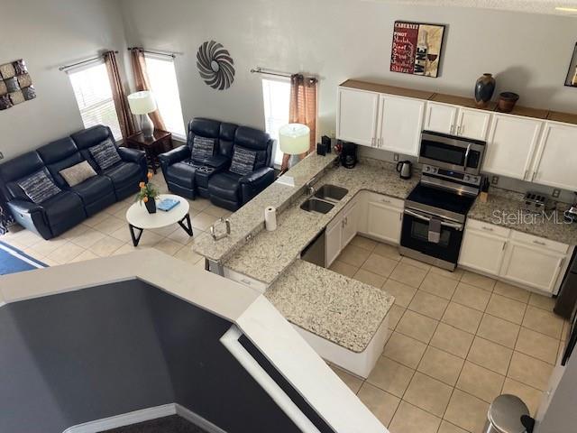 954 Lockbreeze Dr, Davenport, FL 33897 - living area with light tile patterned floors and healthy amount of natural light