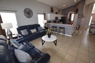 954 Lockbreeze Dr, Davenport, FL 33897 - living area featuring vaulted ceiling and tile patterned floors