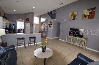 954 Lockbreeze Dr, Davenport, FL 33897 - tiled living room with baseboards