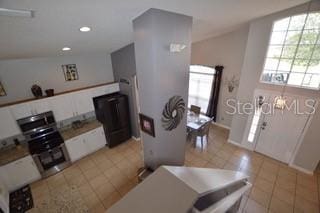 954 Lockbreeze Dr, Davenport, FL 33897 - kitchen with light tile patterned floors, white cabinets, and recessed lighting