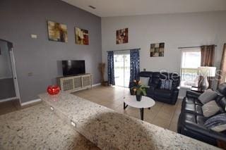 954 Lockbreeze Dr, Davenport, FL 33897 - living room with lofted ceiling and baseboards