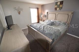 954 Lockbreeze Dr, Davenport, FL 33897 - bedroom featuring baseboards and dark colored carpet