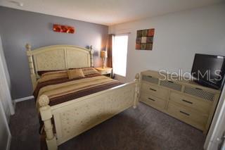 954 Lockbreeze Dr, Davenport, FL 33897 - bedroom featuring dark carpet
