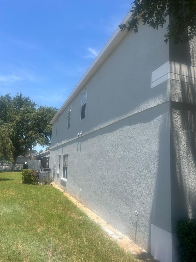 954 Lockbreeze Dr, Davenport, FL 33897 - view of home's exterior featuring stucco siding and a central air condition unit