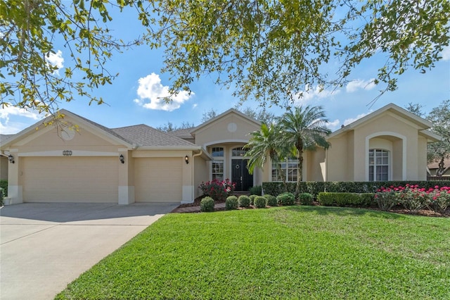 ranch-style home featuring a garage, driveway, a front lawn, and stucco siding