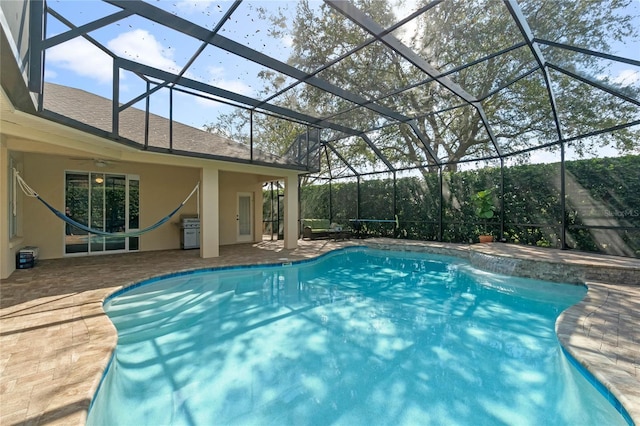 outdoor pool featuring a lanai, a ceiling fan, and a patio