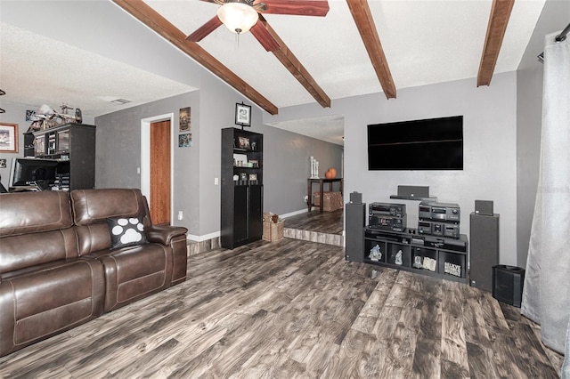 living area featuring lofted ceiling with beams, ceiling fan, baseboards, and wood finished floors