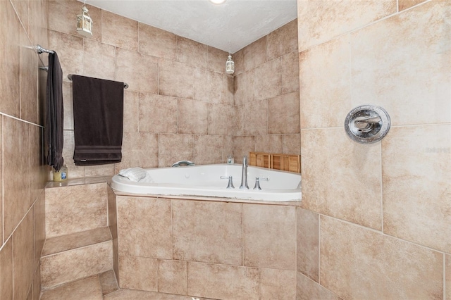 bathroom with a relaxing tiled tub and a tile shower