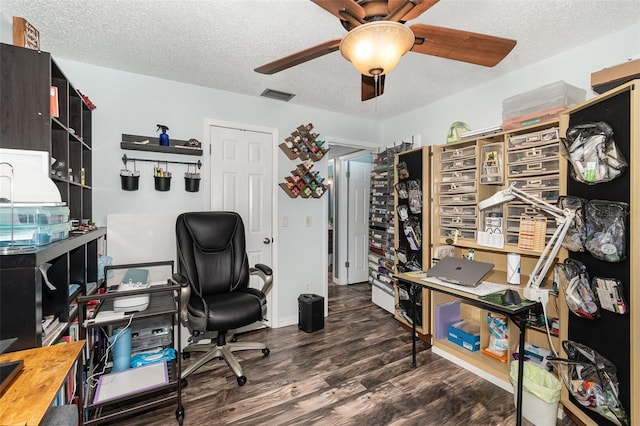 office area featuring a textured ceiling, wood finished floors, visible vents, and a ceiling fan