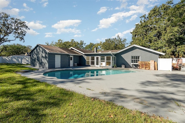 view of pool featuring a patio area, fence, a sunroom, and a fenced in pool