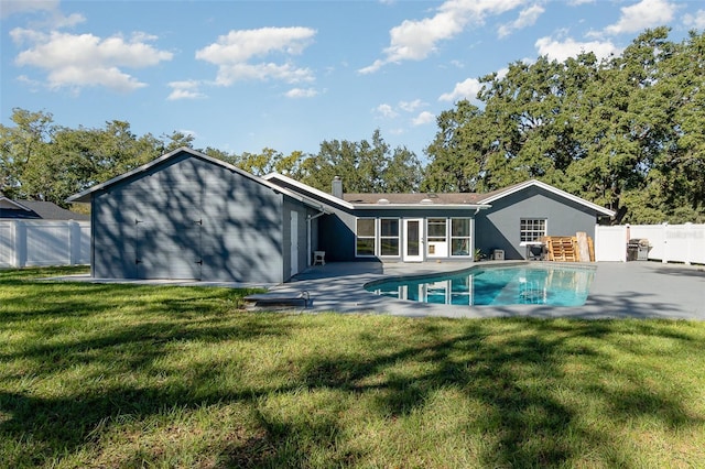 back of property with a patio, a lawn, fence, and a fenced in pool