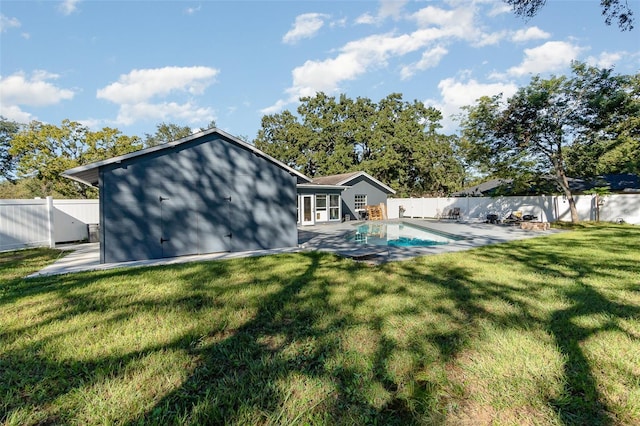 rear view of property with a patio area, a fenced backyard, a fenced in pool, and a yard