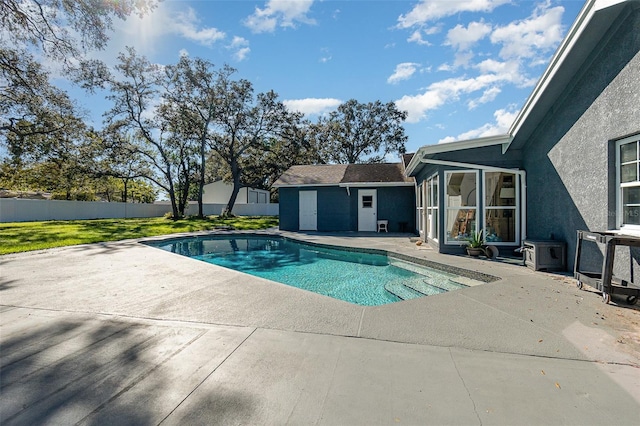 view of pool with a lawn, fence, a fenced in pool, and a patio