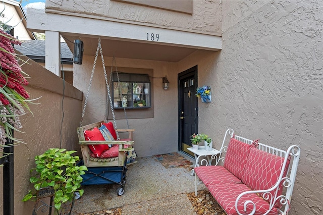 property entrance with stucco siding