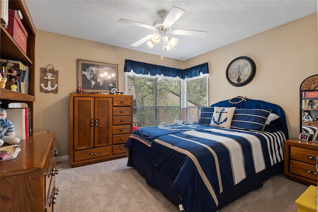 bedroom featuring a textured ceiling, a ceiling fan, and light colored carpet