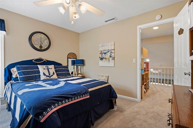 bedroom featuring visible vents, a ceiling fan, carpet flooring, a textured ceiling, and baseboards