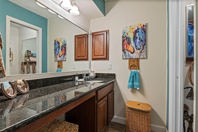 bathroom featuring baseboards, vanity, and tile patterned floors