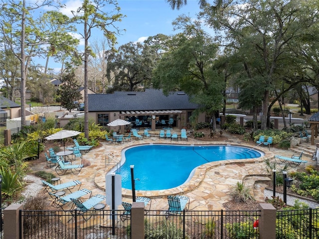 pool featuring a patio area and fence